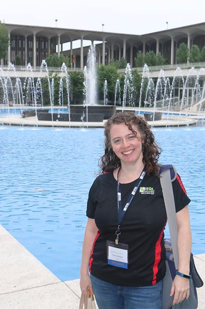 Me standing in front of a water fountain at the SQL Saturday Albany venue wearing my speaker shirt.